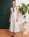 Sleeveless white linen dress: ALÉMAIS Lucky Lace Up Midi Dress in ivory featuring a high round neck with collar tie details. LUXAMORE