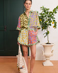 Alemais Patty Spliced Short in 100% hemp multi-color print – Front view on model showing the relaxed mini silhouette and drawstring waistband.. LUXAMORE
