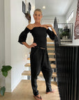Estilo Emporio Fiorella Top - Black worn by model in natural setting LUXAMORE