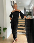 Estilo Emporio Fiorella Top - Black worn by model in natural setting LUXAMORE