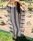 Estilo Emporio Polla Maxi Kaftan Dark Chocolate Stripe worn by model in natural setting LUXAMORE