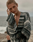 Estilo Emporio Luella Cardigan - Black Multi sustainable knit worn by model at the beach LUXAMORE