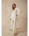 Estilo Emporio Linen Pant Novo Flare - Brasile Panna White worn by model in natural setting LUXAMORE