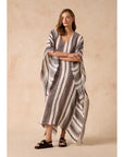 Estilo Emporio Polla Maxi Kaftan Dark Chocolate Stripe worn by model in natural setting LUXAMORE