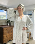 Estilo Emporio Stella Linen Dress - Binario worn by model in natural setting LUXAMORE