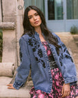 Floral Cosmos Denim Boho Embroidered Overshirt worn by model in natural setting LUXAMORE