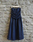 Italian Linen Dress Strapless Navy worn by model in natural setting LUXAMORE