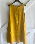 Linen Dress Midi A Line Pockets Made in Italy Yellow worn by model in natural setting LUXAMORE