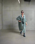 Linen Dress Oversize Maxi Kaftan Made in Italy Olive worn by model in natural setting LUXAMORE