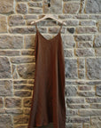 Linen Slip Dress Midi Made in Italy Brown worn by model in natural setting LUXAMORE