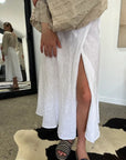 Linen Wrap Skirt With Pockets Made in Italy White worn by model in natural setting LUXAMORE