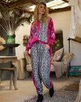 Miss Goodlife Pink Animal Love Pants worn by model in natural setting LUXAMORE