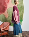 Luxury wool-blend knitwear: ALÉMAIS MLAK oversized cardigan showing soft light pink sleeves and button closure.. LUXAMORE