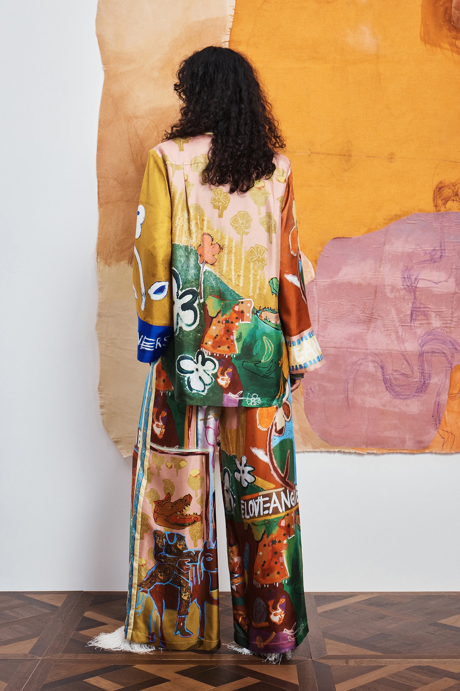 Wide-leg silk pants: ALÉMAIS MLAK Silk Pant featuring a relaxed fluid silhouette and vibrant multicolor graphic print.. LUXAMORE