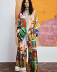 Luxury resort-wear trousers: ALÉMAIS MLAK printed silk pants showing the comfortable pull-on fit and in-seam pockets.. LUXAMORE