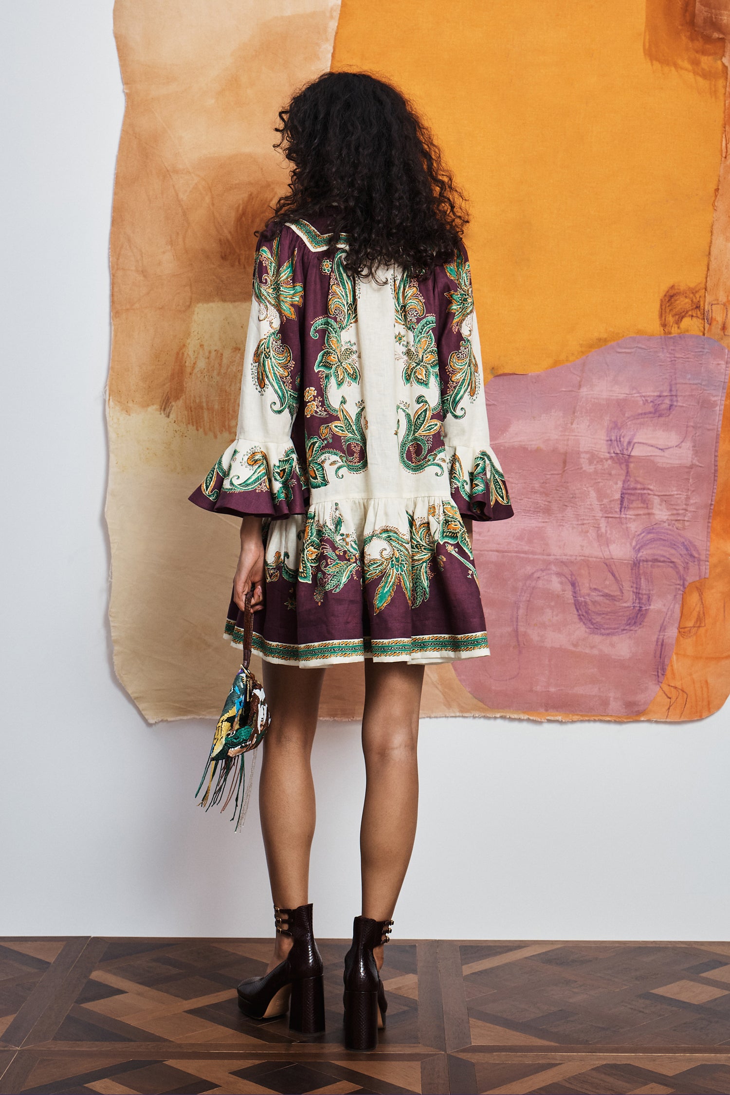.Feminine resort mini dress: ALÉMAIS Ruthie dress showing the matching self-tie rouleau belt and fluid ruffle hem. LUXAMORE