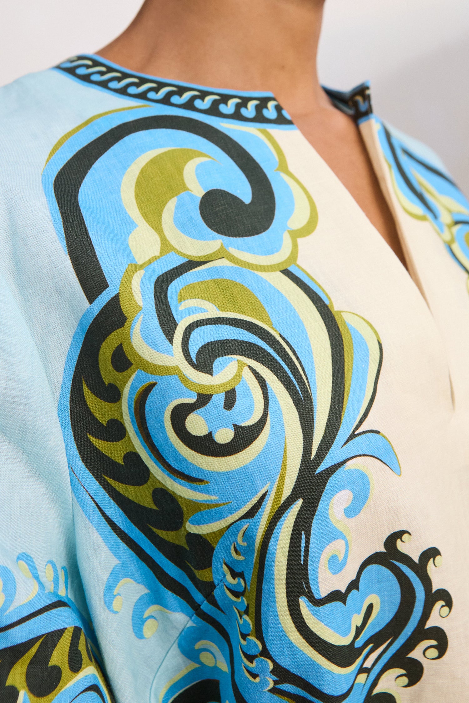 Premium resort-wear fashion: Close-up of the breathable European flax linen and cropped sleeves on the Natalia dress.. LUXAMORE