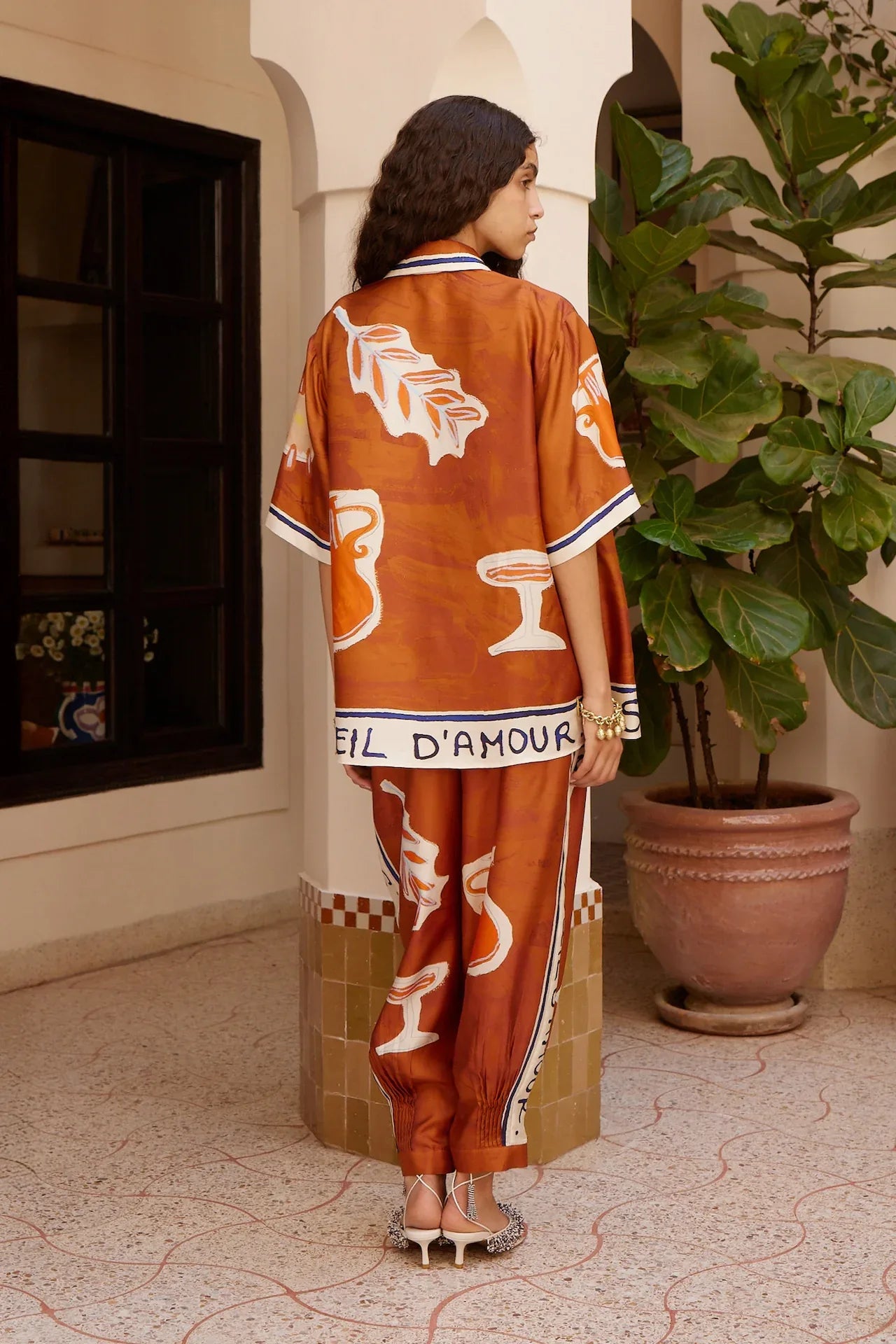 Alemais Soleil d’Amour Silk Shirt worn by model in natural setting LUXAMORE 