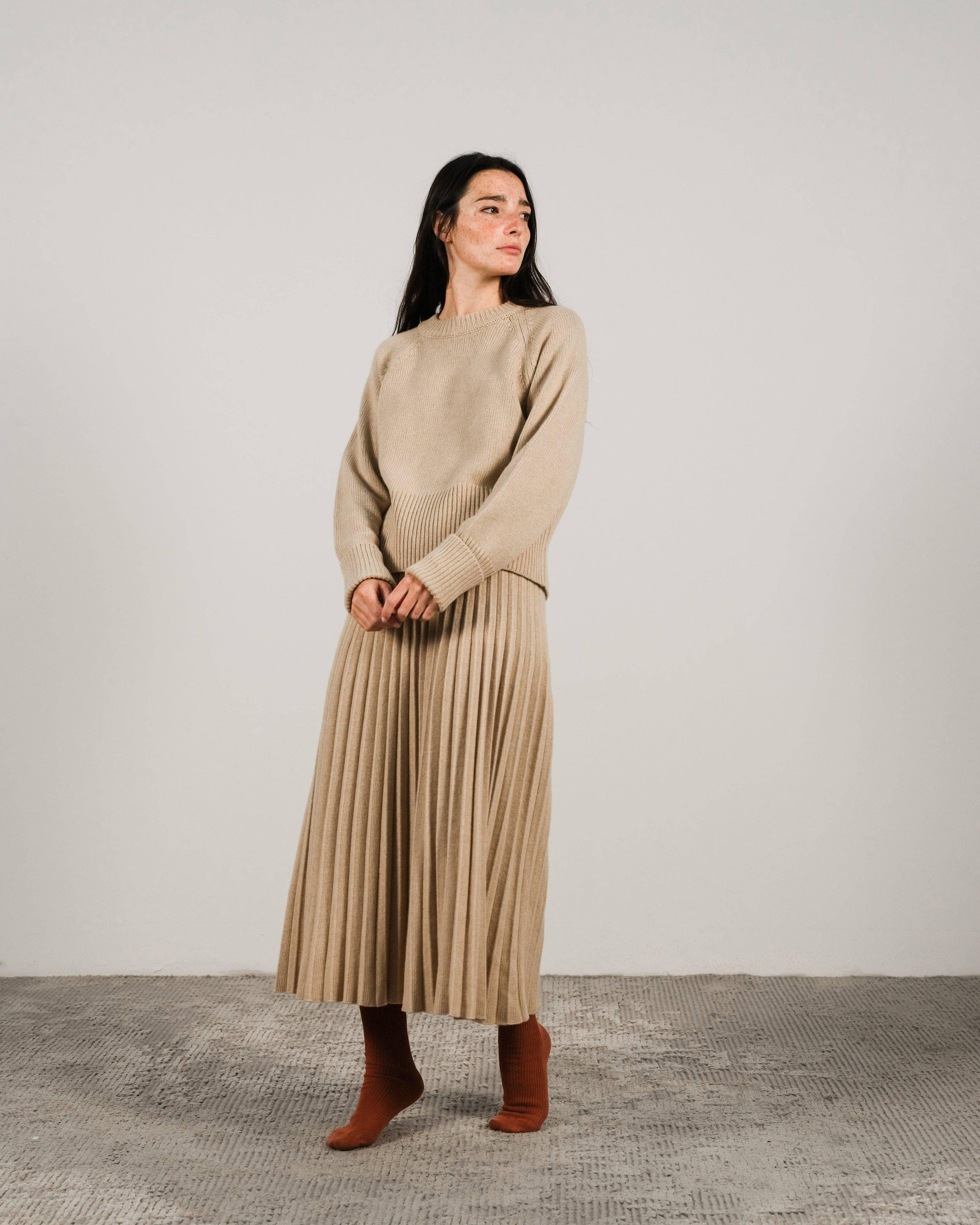 Cashmere pleated skirt Made in Italy by Lemme - Caramello worn by model in natural setting LUXAMORE 
