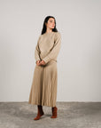 Cashmere pleated skirt Made in Italy by Lemme - Caramello worn by model in natural setting LUXAMORE 