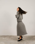 Cashmere pleated skirt Made in Italy by Lemme - Caramello worn by model in natural setting LUXAMORE 