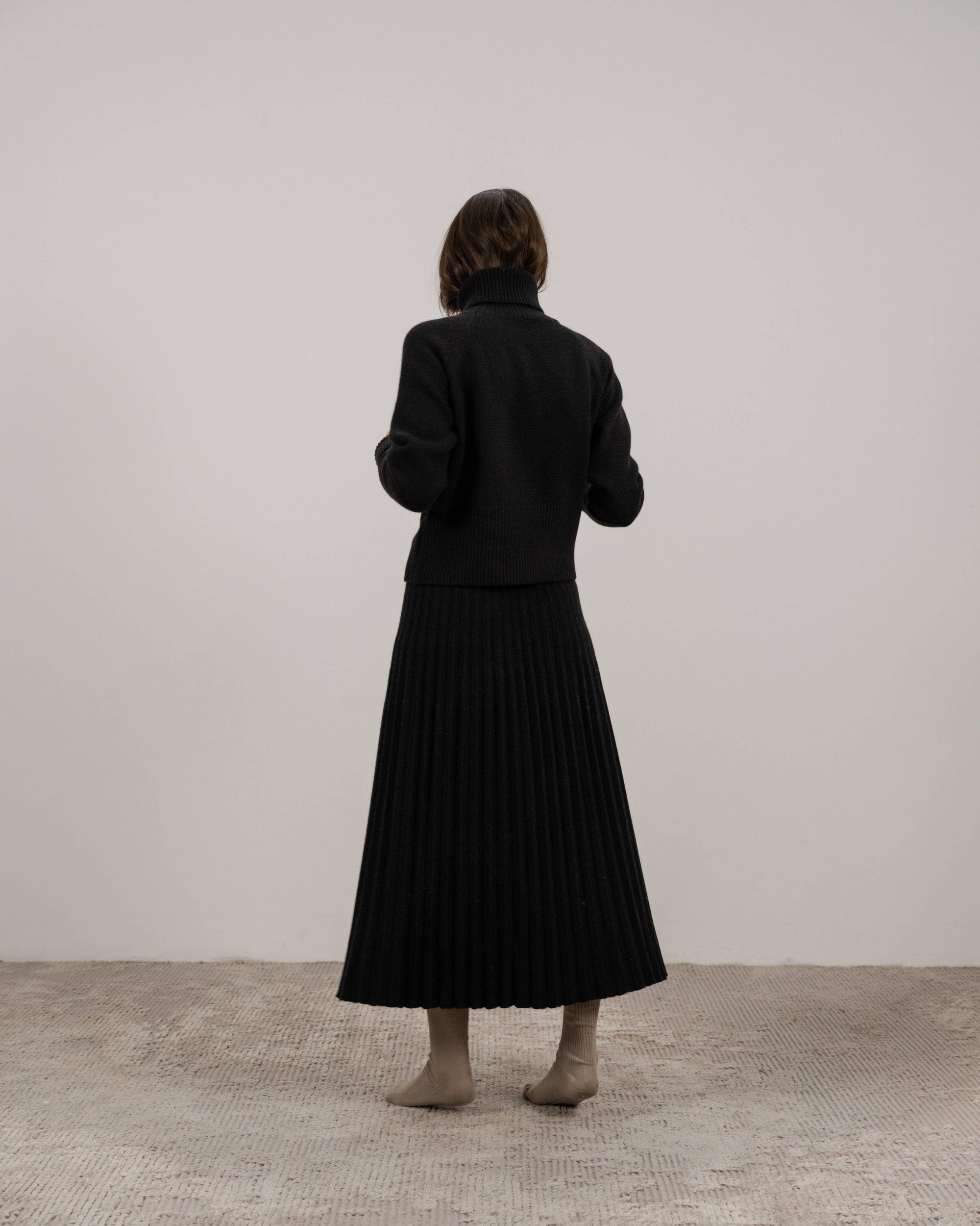 Cashmere pleated skirt Made in Italy by Lemme - Caramello worn by model in natural setting LUXAMORE 