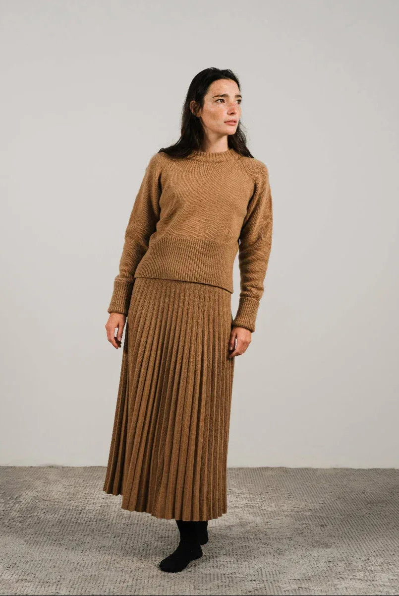 Cashmere pleated skirt Made in Italy by Lemme - Caramello worn by model in natural setting LUXAMORE 