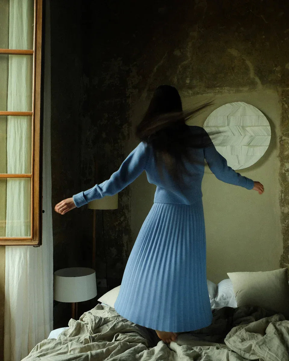 Cashmere pleated skirt Made in Italy by Lemme - Caramello worn by model in natural setting LUXAMORE 