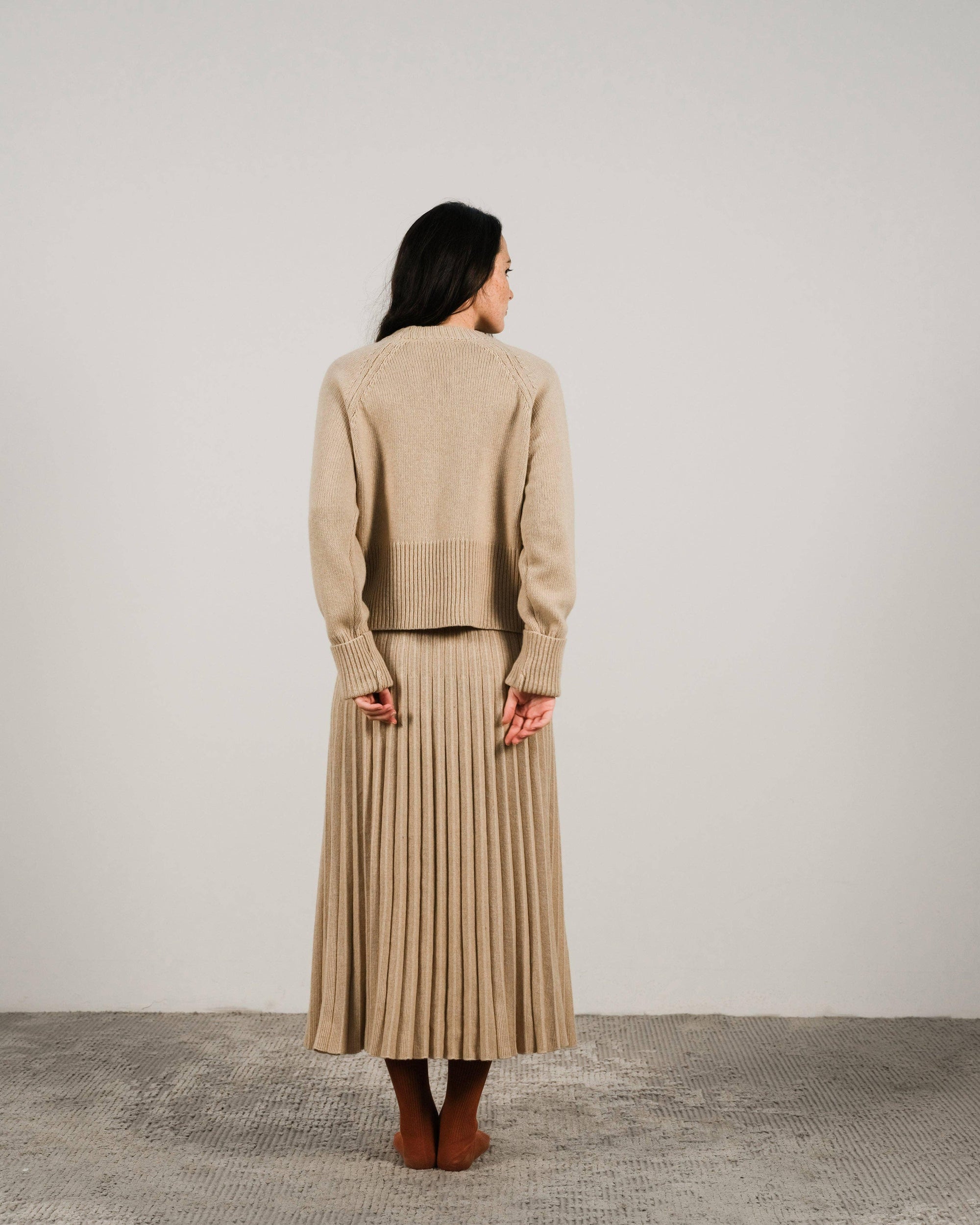 Cashmere pleated skirt Made in Italy by Lemme - Caramello worn by model in natural setting LUXAMORE 