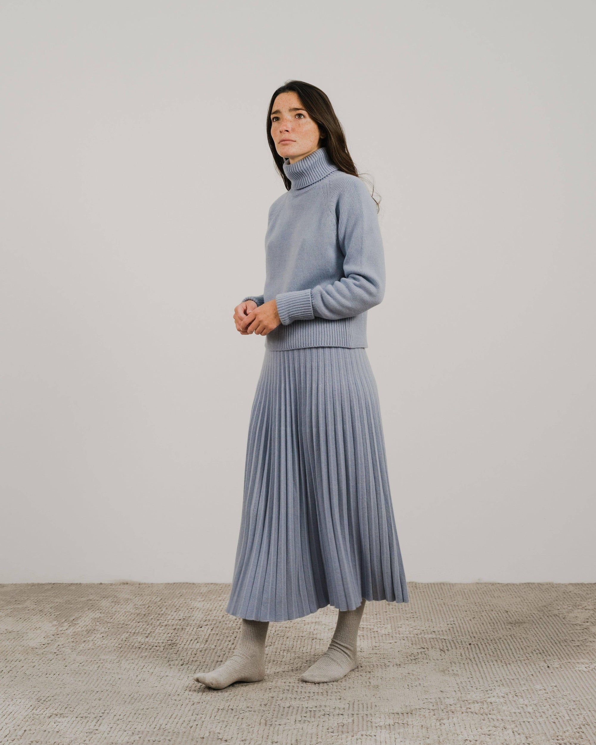 Cashmere pleated skirt Made in Italy by Lemme - Caramello worn by model in natural setting LUXAMORE 