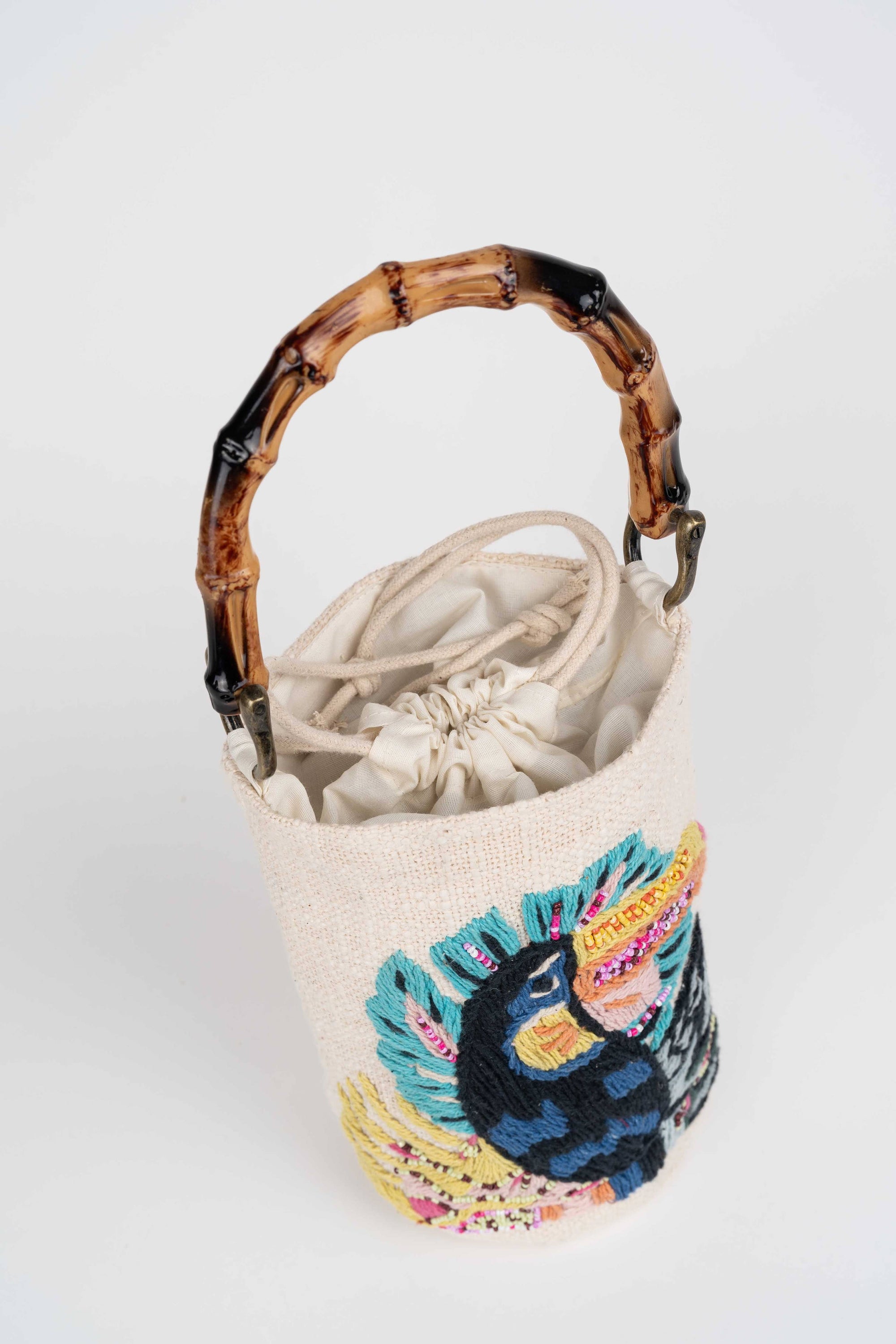 Curaco White Handbag Toucan worn by model in natural setting LUXAMORE 