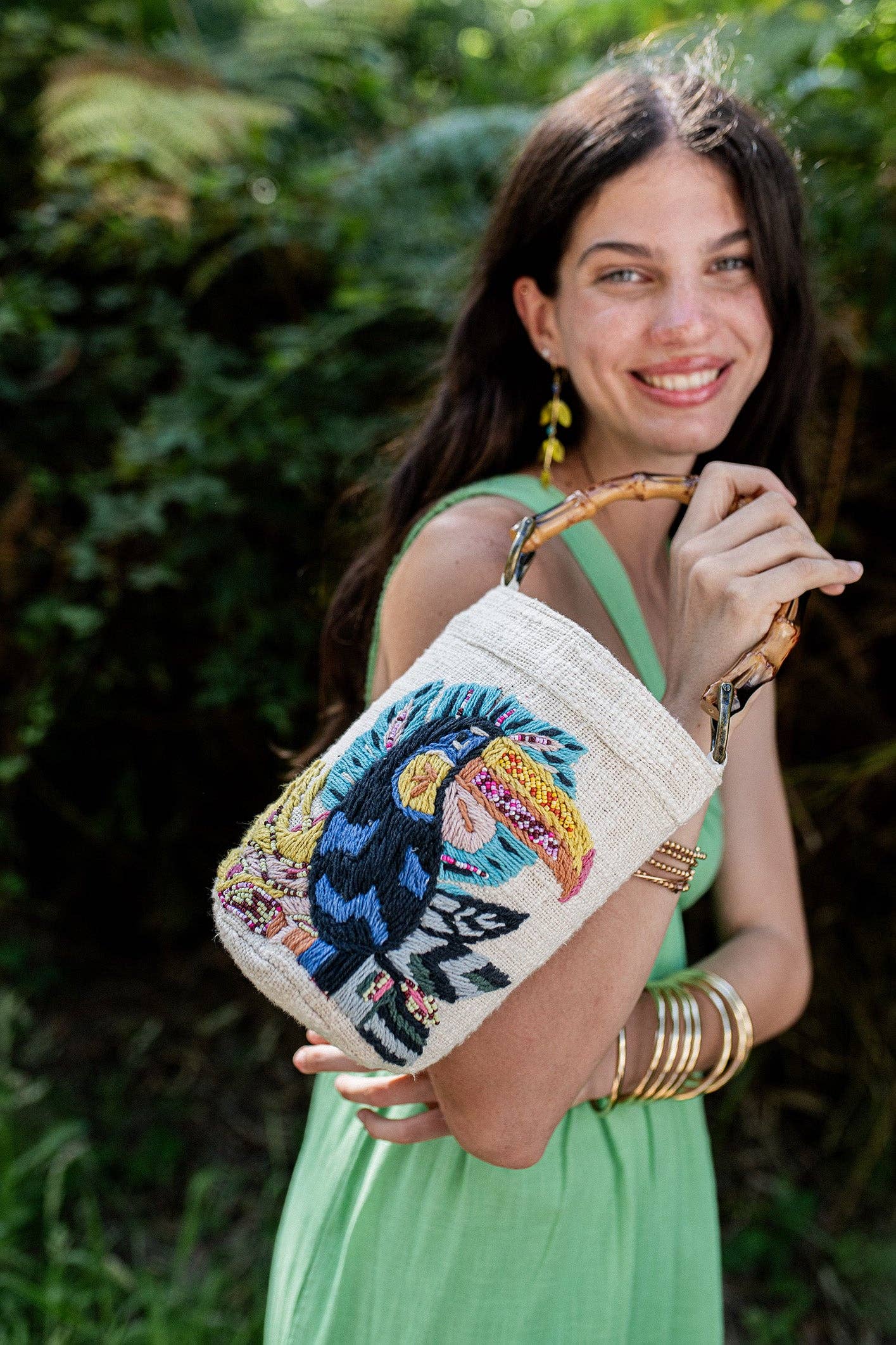 Curaco White Handbag Toucan worn by model in natural setting LUXAMORE 