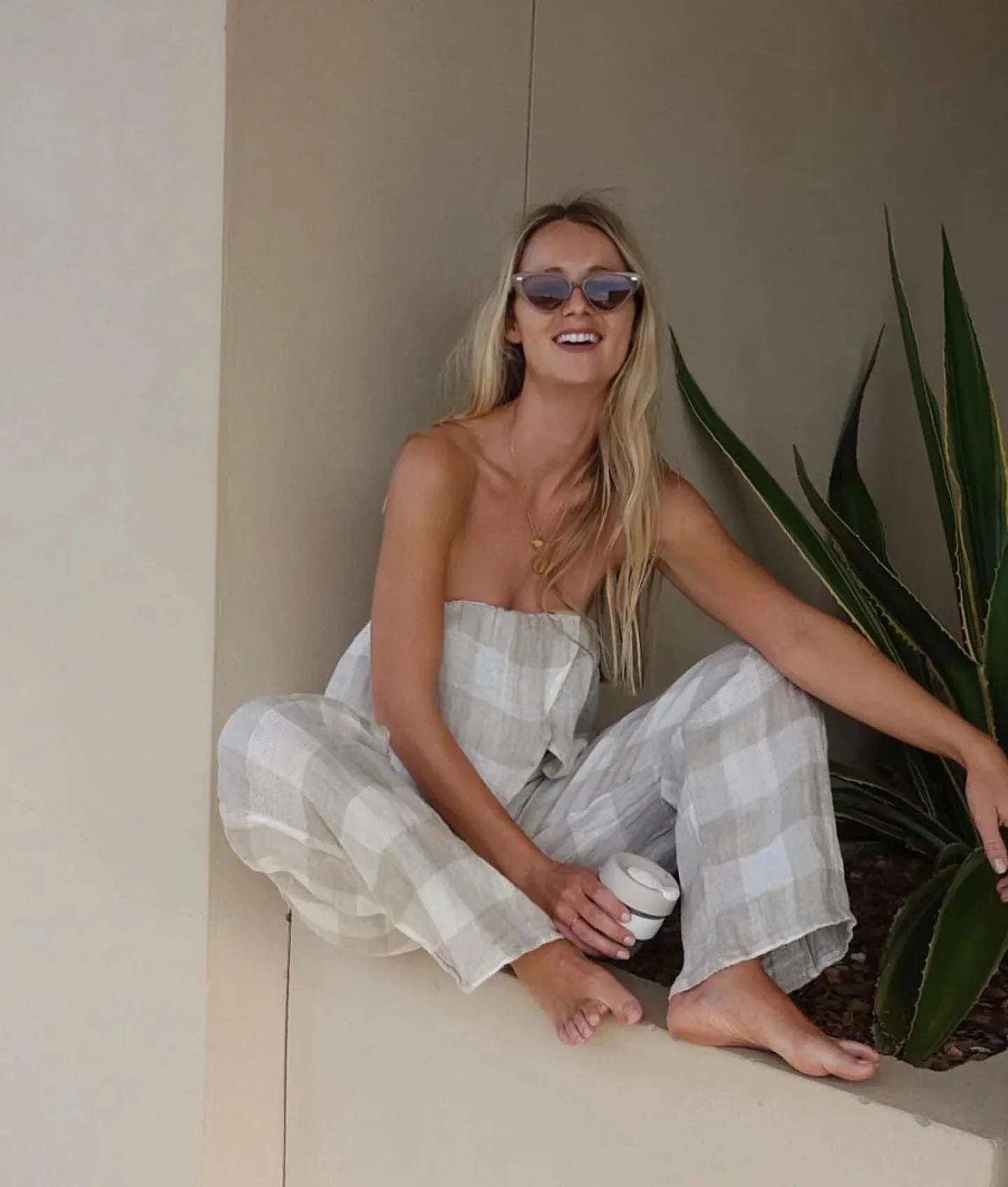 Estillo Emporio Papillion Jumpsuit - Panna White worn by model in natural setting LUXAMORE 