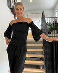 Estilo Emporio Fiorella Top - Black worn by model in natural setting LUXAMORE 