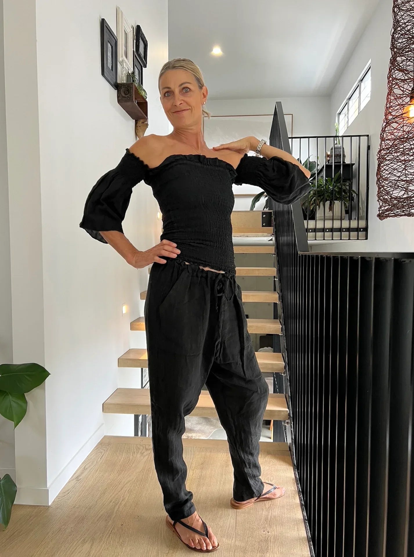 Estilo Emporio Fiorella Top - Black worn by model in natural setting LUXAMORE 