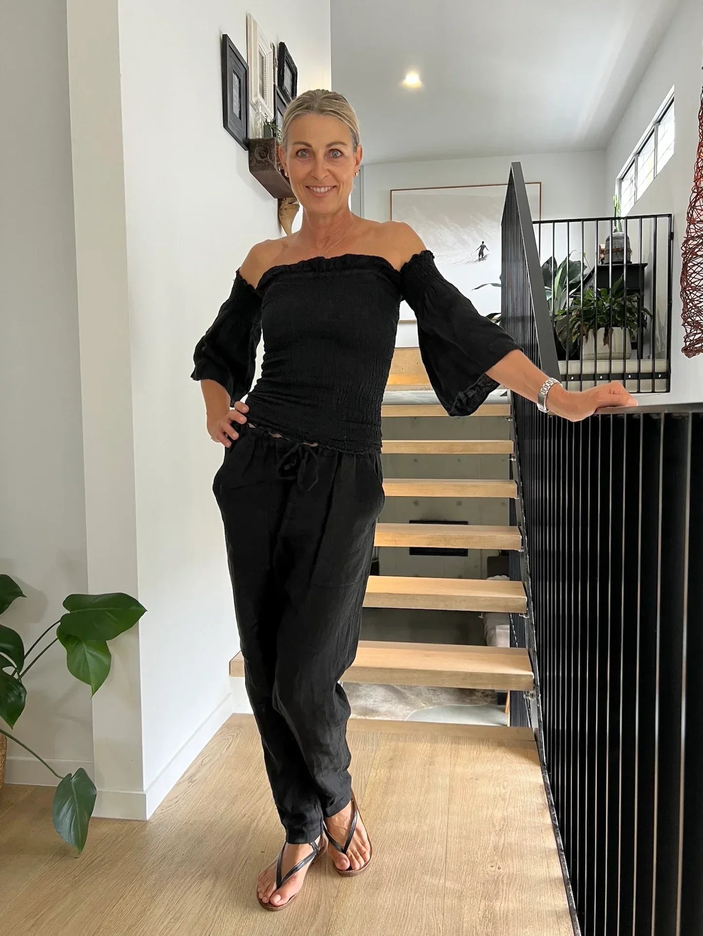 Estilo Emporio Fiorella Top - Black worn by model in natural setting LUXAMORE 