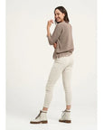 Estilo Emporio Linen Pant Stretch- Natural worn by model in natural setting LUXAMORE 