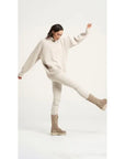 Estilo Emporio Linen Pant Stretch- Natural worn by model in natural setting LUXAMORE 