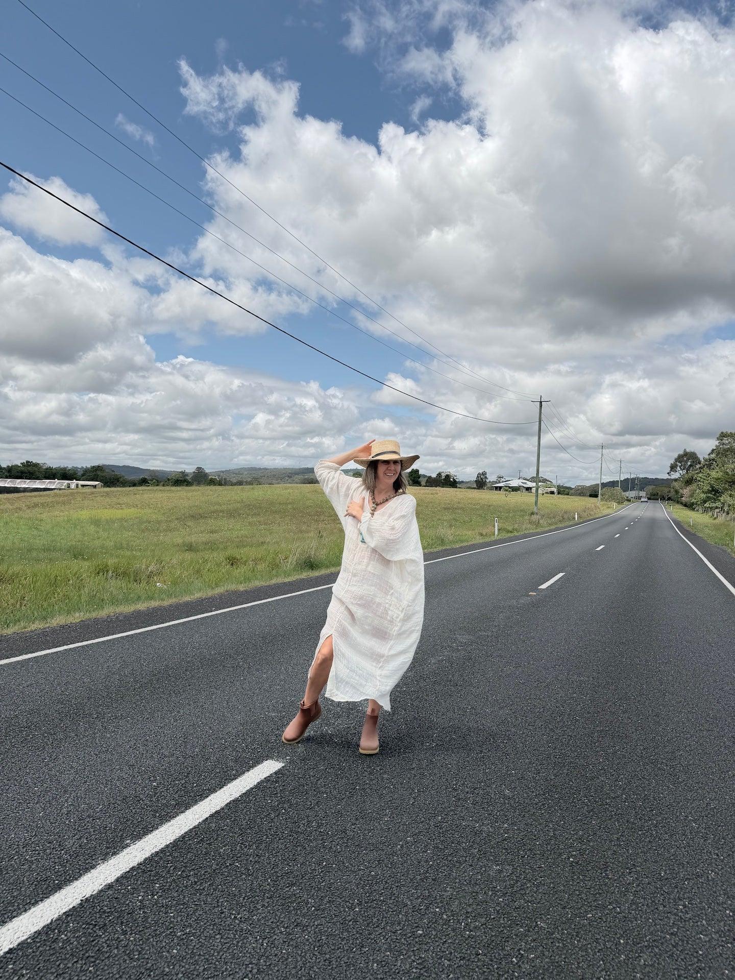 Estilo Emporio Neve Linen Dress -Tela Atena Panna worn by model in natural setting LUXAMORE 