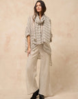 Estilo Emporio Linen Pant Novo Flare - Brasile Natural worn by model in natural setting LUXAMORE 