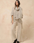 Estilo Emporio Linen Pant Novo Flare - Brasile Natural worn by model in natural setting LUXAMORE 