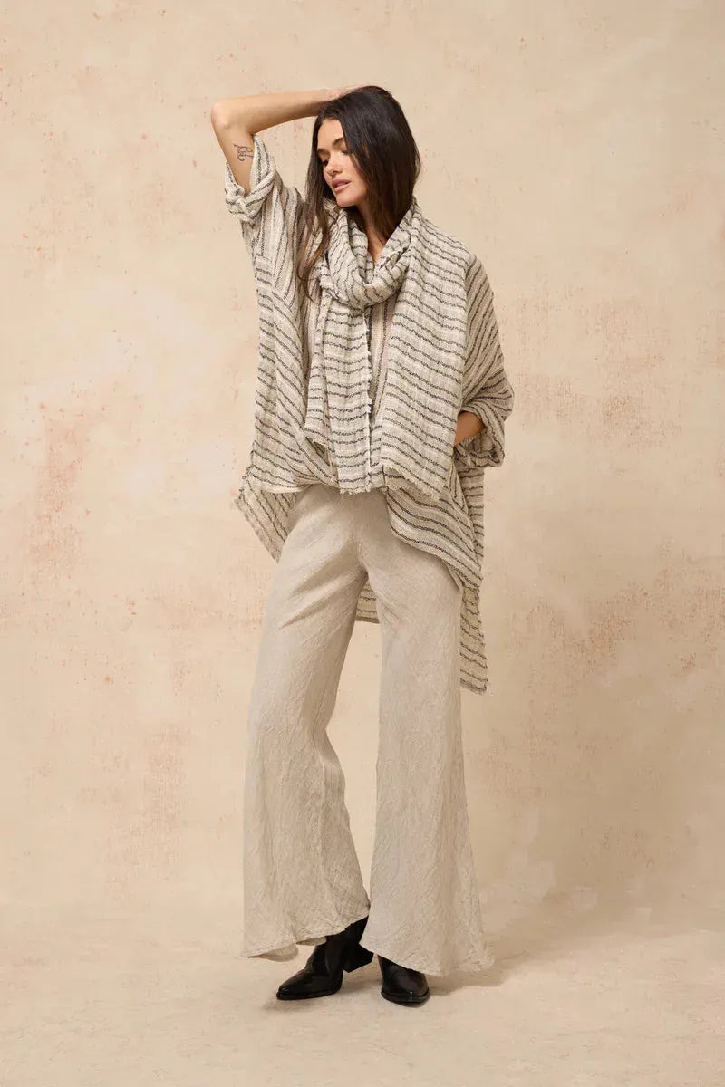 Estilo Emporio Linen Pant Novo Flare - Brasile Natural worn by model in natural setting LUXAMORE 