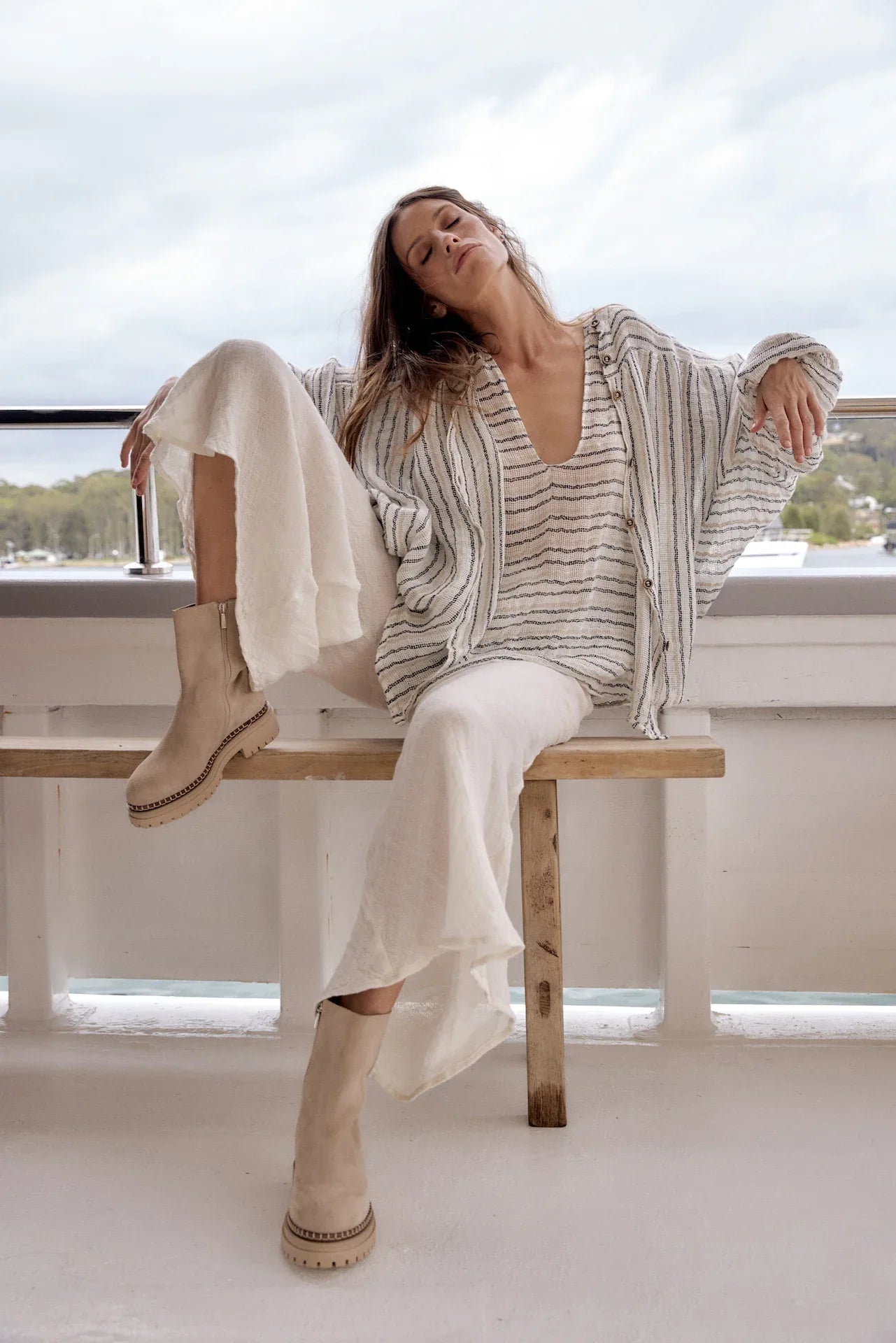 Estilo Emporio Linen Pant Novo Flare - Brasile Panna White worn by model in natural setting LUXAMORE 
