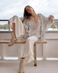 Estilo Emporio Linen Pant Novo Flare - Brasile Panna White worn by model in natural setting LUXAMORE 