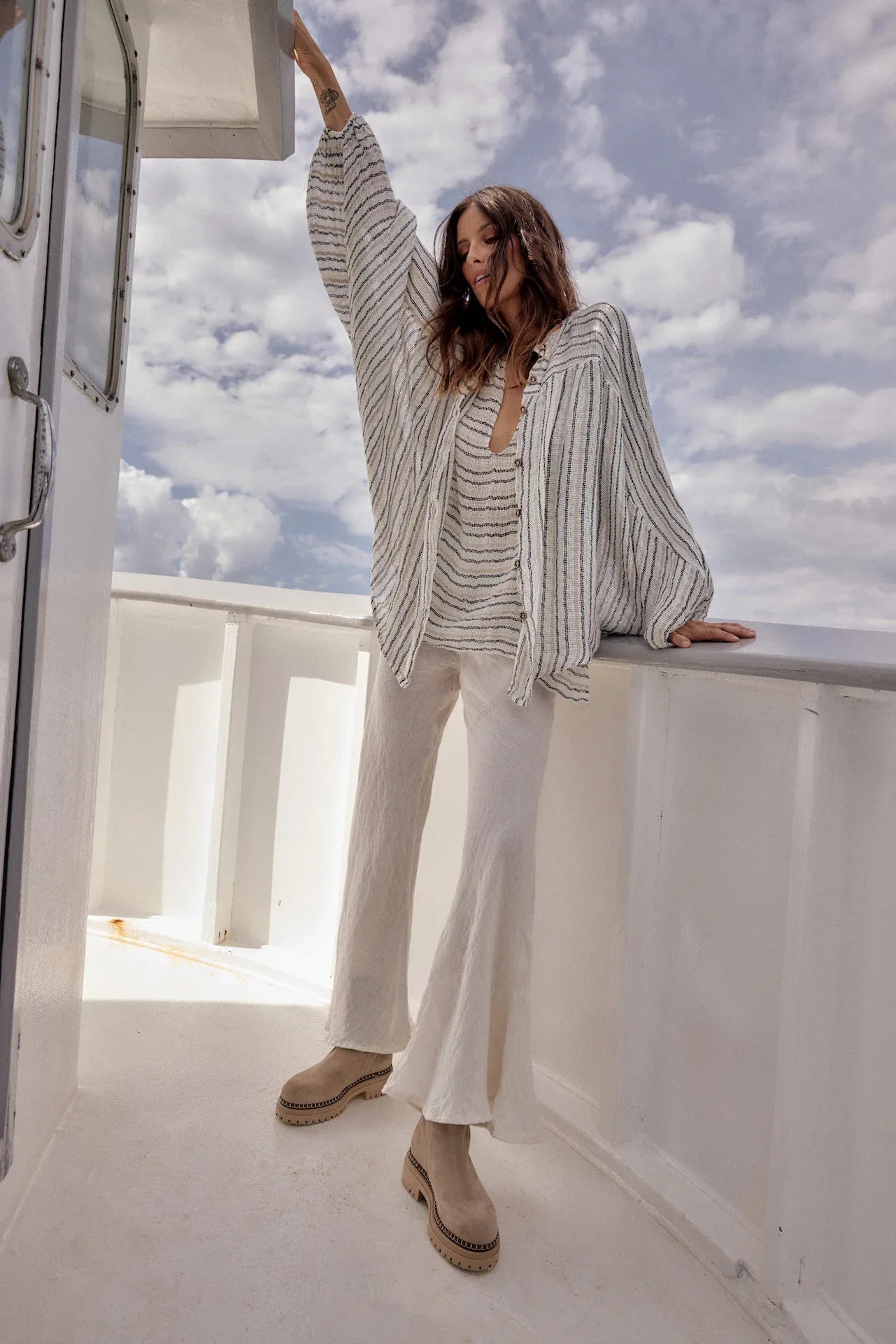 Estilo Emporio Linen Pant Novo Flare - Brasile Panna White worn by model in natural setting LUXAMORE 