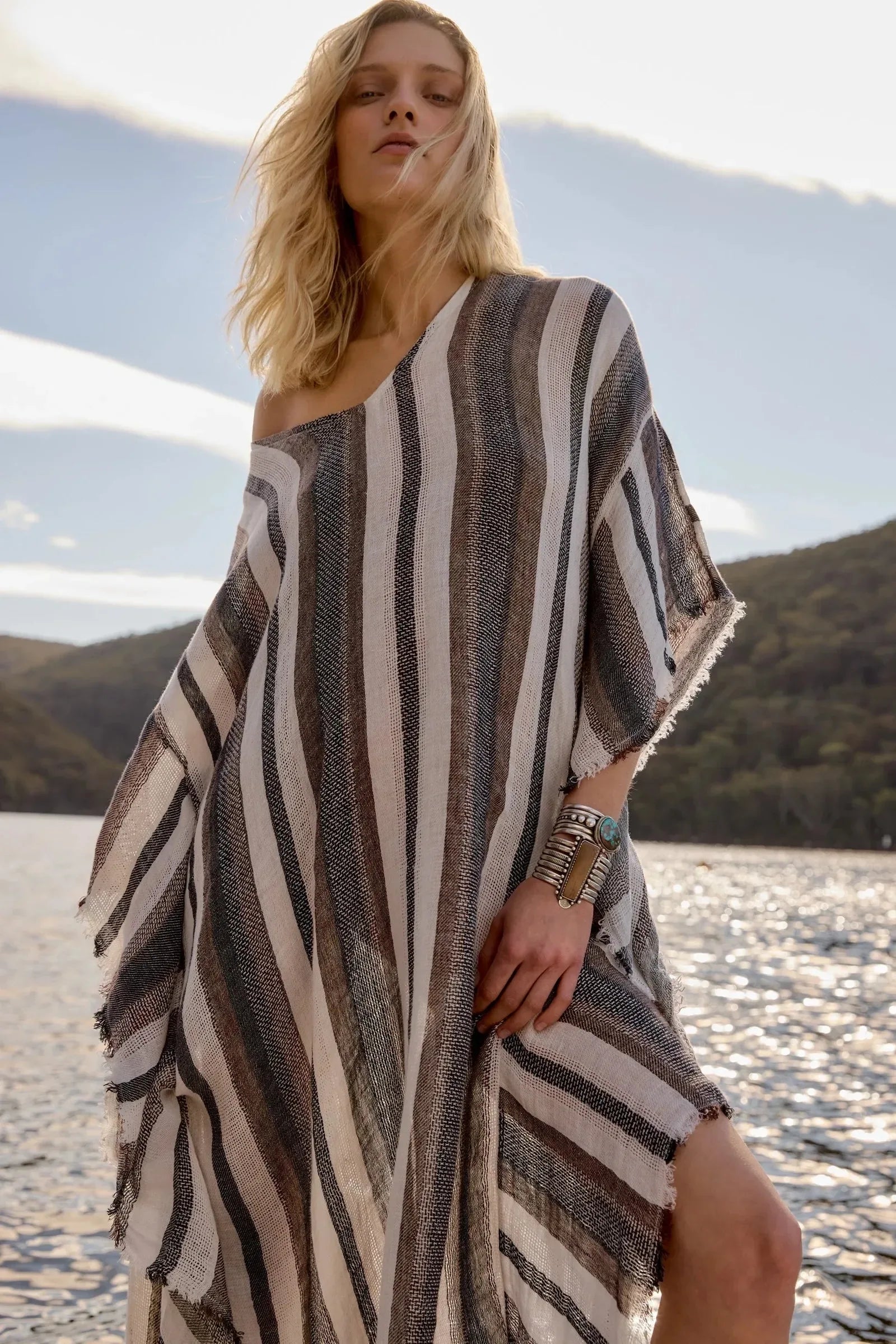 Estilo Emporio Polla Maxi Kaftan Dark Chocolate Stripe worn by model in natural setting LUXAMORE 
