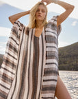 Estilo Emporio Polla Maxi Kaftan Dark Chocolate Stripe worn by model in natural setting LUXAMORE 