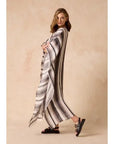 Estilo Emporio Polla Maxi Kaftan Dark Chocolate Stripe worn by model in natural setting LUXAMORE 