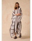 Estilo Emporio Polla Maxi Kaftan Dark Chocolate Stripe worn by model in natural setting LUXAMORE 