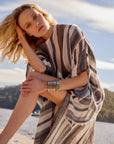 Estilo Emporio Polla Maxi Kaftan Dark Chocolate Stripe worn by model in natural setting LUXAMORE 